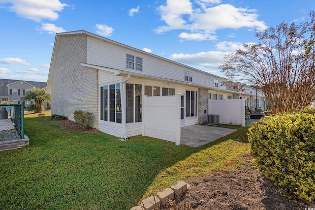 back of house featuring a yard, a patio area, and central AC