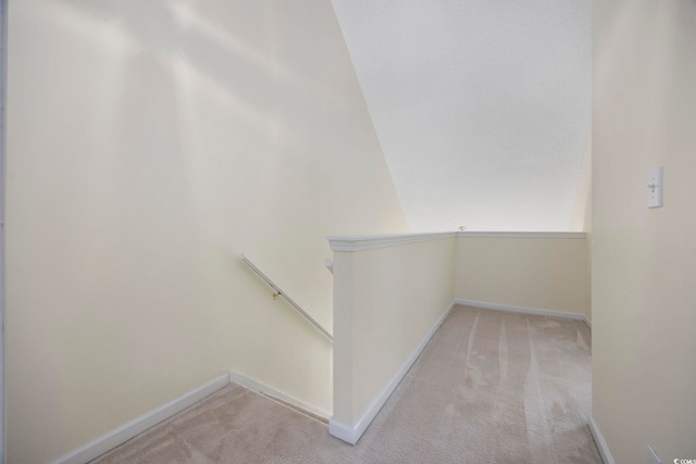 interior space with vaulted ceiling and carpet flooring