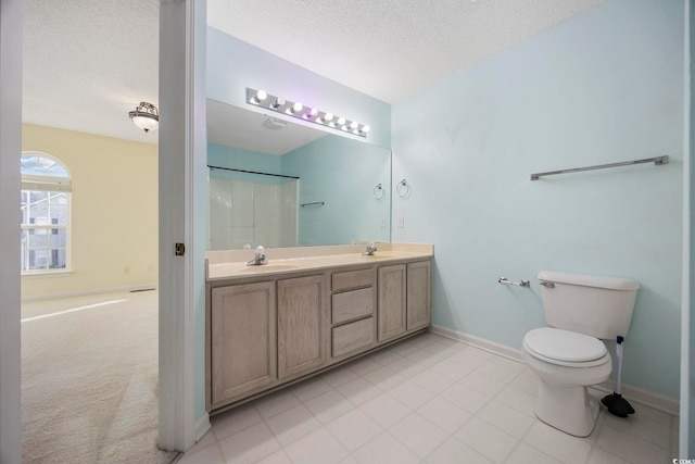 bathroom featuring toilet, a textured ceiling, walk in shower, and vanity