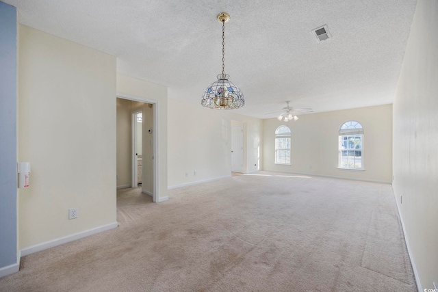 carpeted empty room with a textured ceiling and ceiling fan