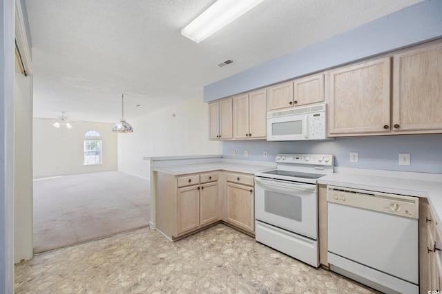 kitchen featuring white appliances, light carpet, light brown cabinetry, and a textured ceiling