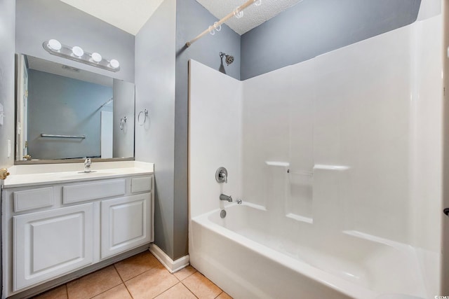 bathroom featuring vanity, washtub / shower combination, a textured ceiling, and tile patterned flooring