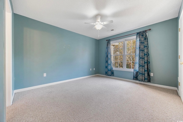 carpeted spare room featuring a textured ceiling and ceiling fan