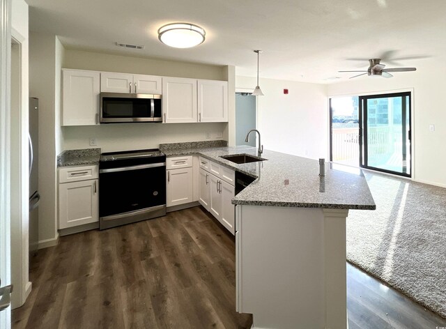 kitchen with white cabinetry, stainless steel appliances, sink, and pendant lighting