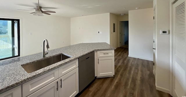 kitchen with white cabinetry, stainless steel dishwasher, sink, and light stone counters