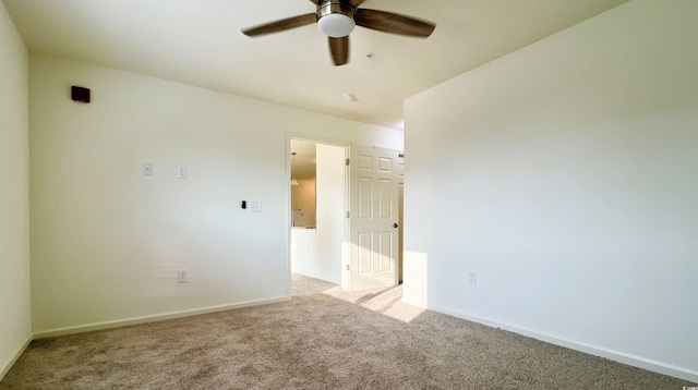 unfurnished room featuring carpet floors, ceiling fan, and baseboards