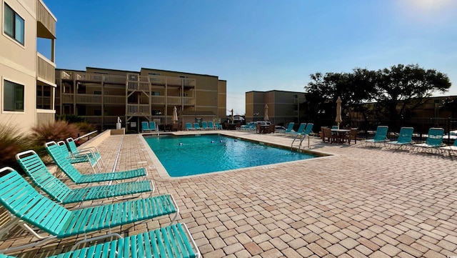 view of swimming pool featuring a patio area