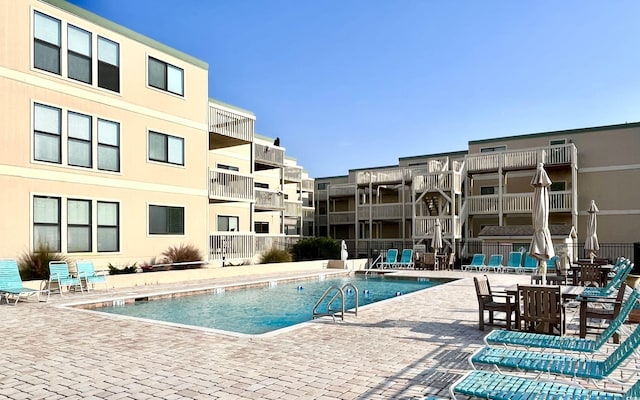 community pool featuring fence and a patio area