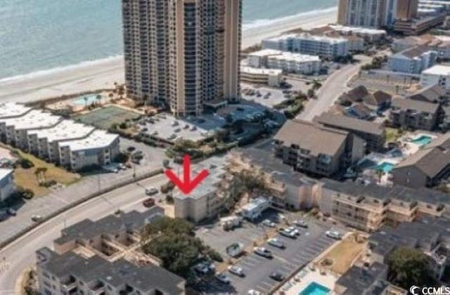 aerial view with a water view and a beach view