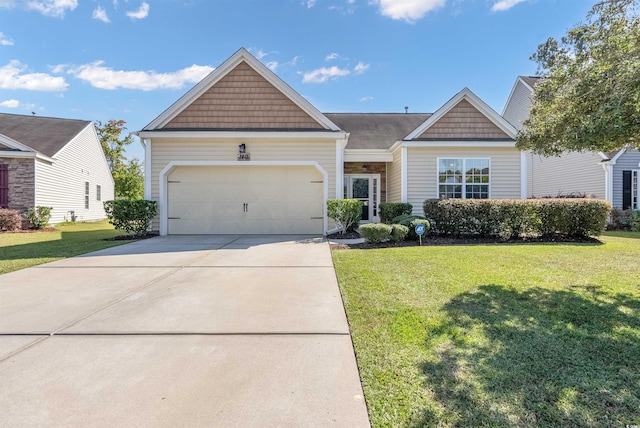 view of front of property with a front yard and a garage