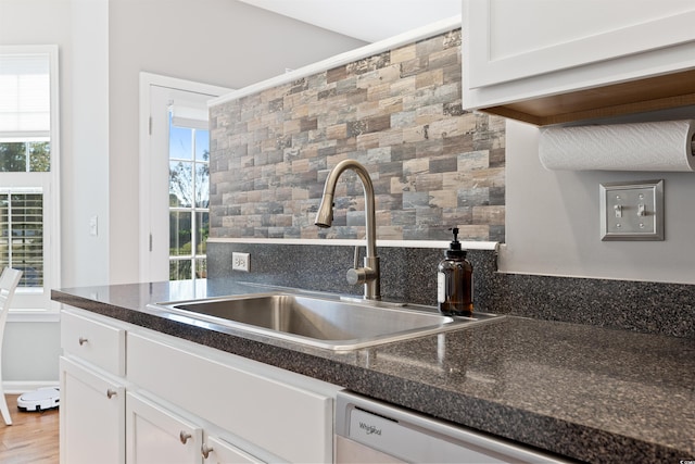 kitchen with white cabinetry, sink, and plenty of natural light