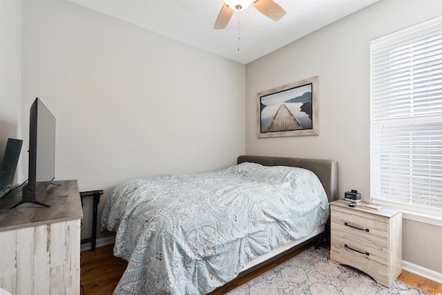 bedroom with ceiling fan and wood-type flooring