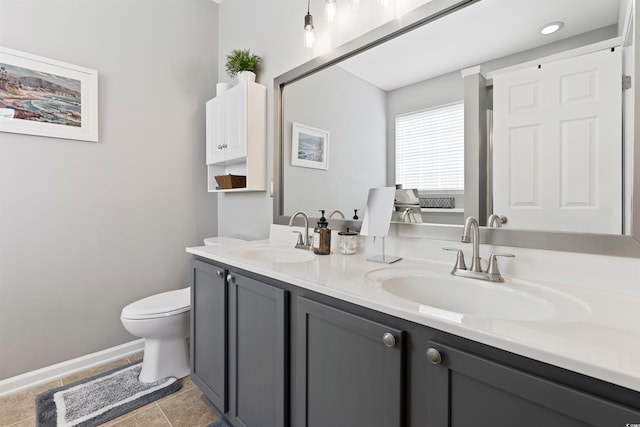 bathroom featuring toilet, vanity, and tile patterned floors