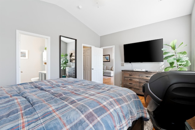 bedroom with ensuite bath and lofted ceiling