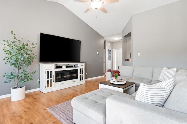 living room featuring ceiling fan, hardwood / wood-style flooring, and lofted ceiling