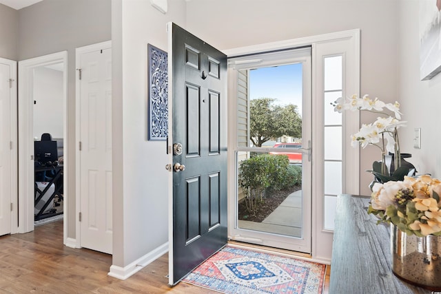 foyer entrance featuring wood finished floors and baseboards