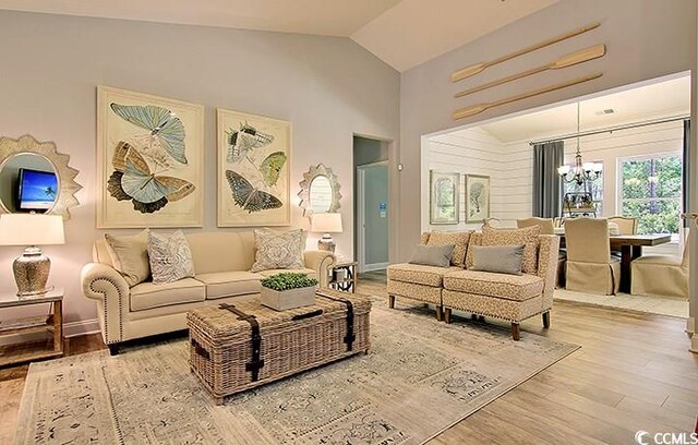 703 Annandale Dr, Myrtle Beach, SC 29588 - living room featuring a chandelier, wood finished floors, and high vaulted ceiling