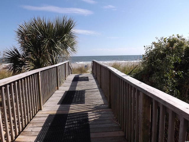 view of property's community featuring a water view and a view of the beach