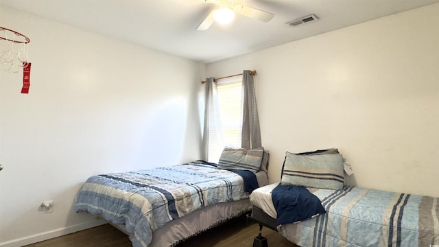 bedroom with dark hardwood / wood-style flooring and ceiling fan