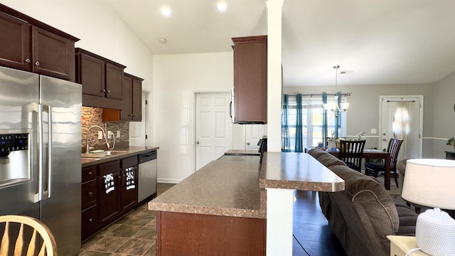 kitchen featuring sink, tasteful backsplash, decorative light fixtures, dark brown cabinets, and appliances with stainless steel finishes