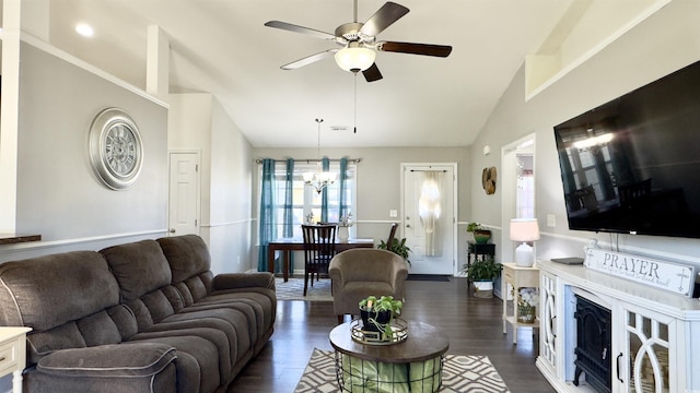 living room with ceiling fan with notable chandelier, dark hardwood / wood-style floors, and vaulted ceiling