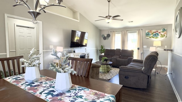 dining space with ceiling fan, high vaulted ceiling, and dark wood-type flooring