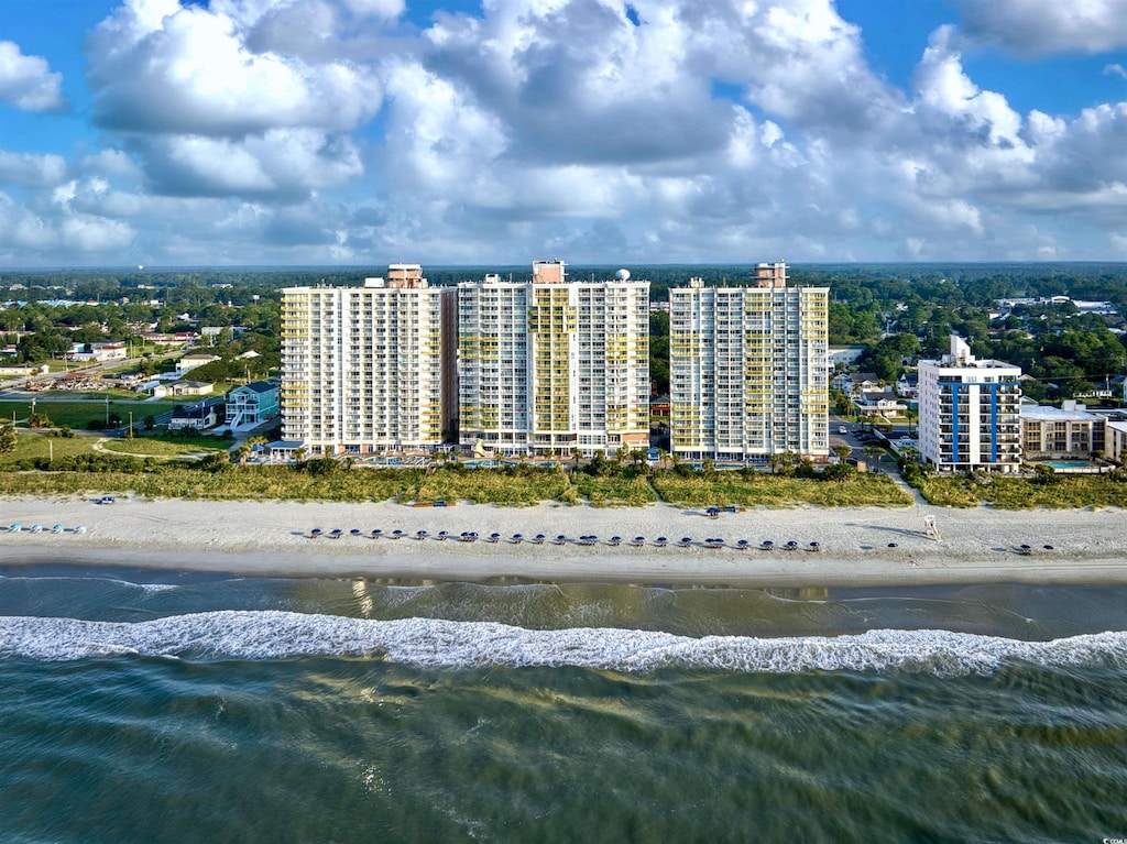 drone / aerial view with a water view and a beach view