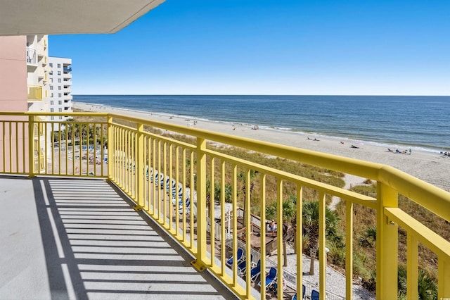 balcony featuring a water view and a beach view