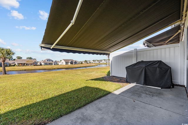 view of yard featuring a patio and a water view