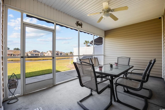 sunroom / solarium featuring ceiling fan