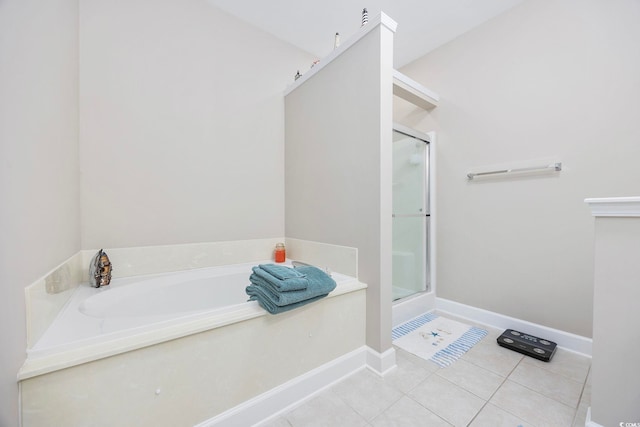 bathroom with shower with separate bathtub and tile patterned floors