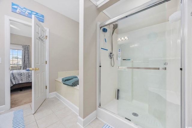 bathroom with an enclosed shower and tile patterned floors