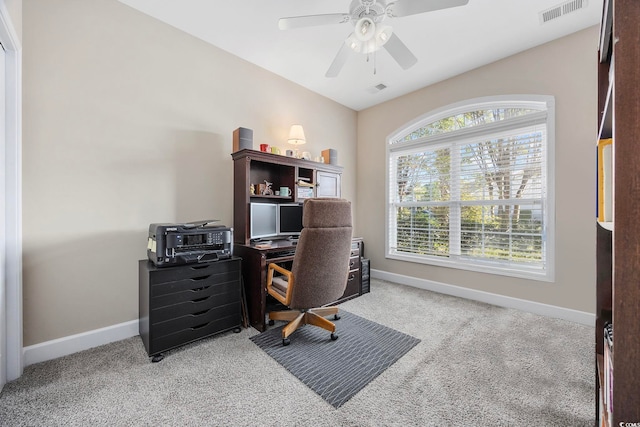 carpeted office space with ceiling fan