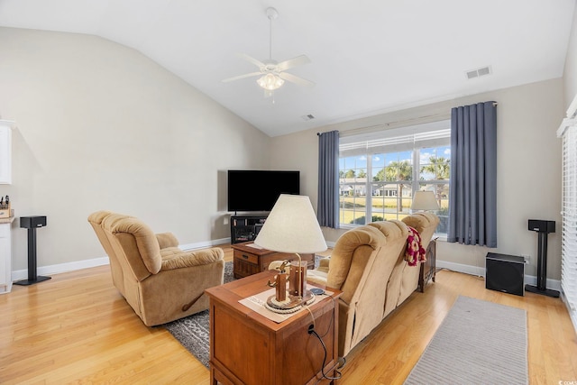 living room with ceiling fan, lofted ceiling, and light hardwood / wood-style floors