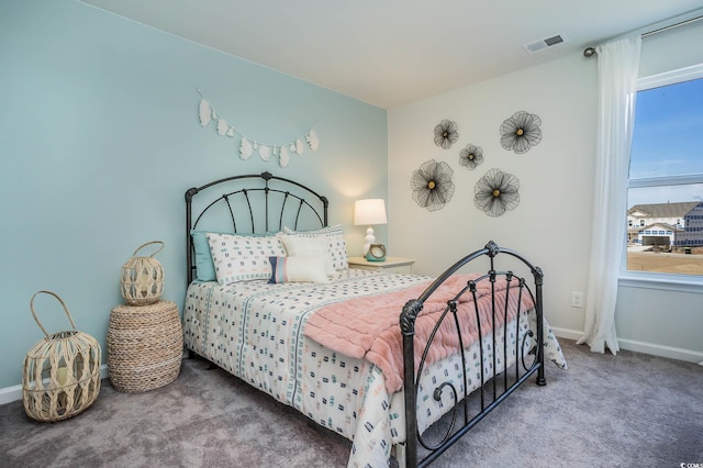 carpeted bedroom featuring multiple windows