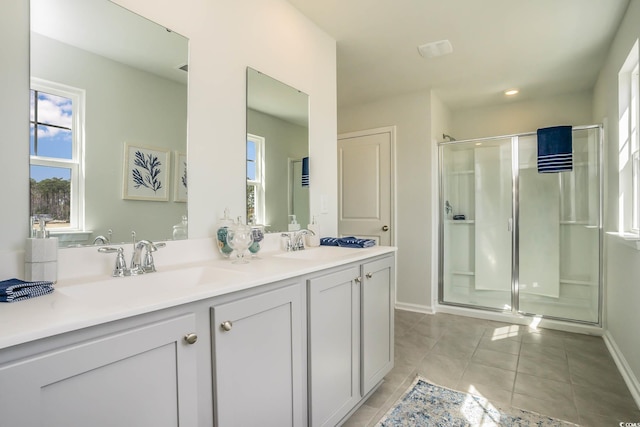 bathroom featuring tile patterned flooring, vanity, and a shower with shower door