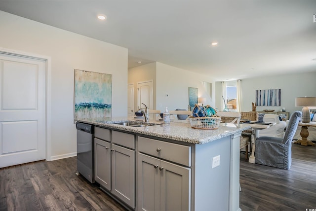 kitchen with dishwasher, sink, dark hardwood / wood-style flooring, gray cabinets, and a kitchen island with sink