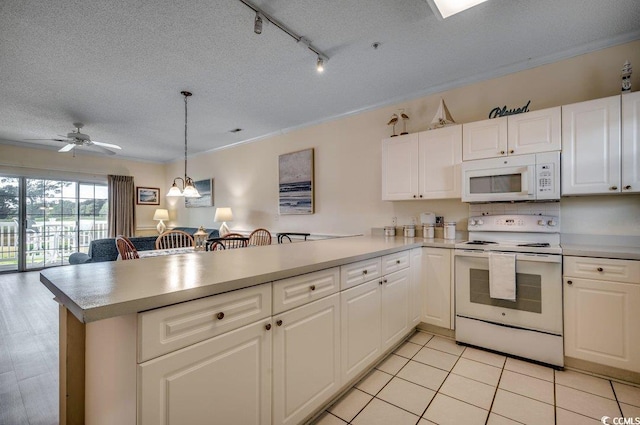 kitchen featuring kitchen peninsula, ceiling fan with notable chandelier, white cabinets, and white appliances