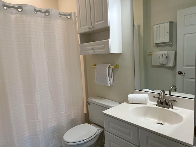 bathroom featuring vanity, curtained shower, and toilet