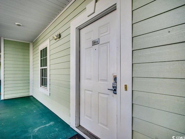 view of exterior entry with covered porch