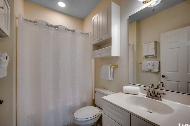 bathroom featuring vanity, a textured ceiling, toilet, and a shower with shower curtain