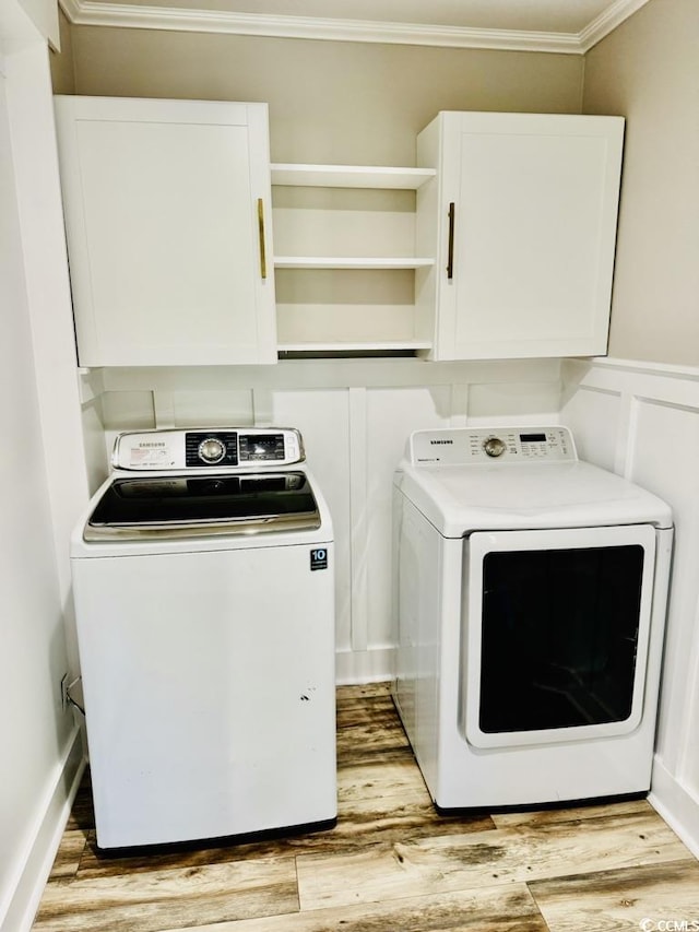 3936 Murrells Inlet Rd, Murrells Inlet, SC 29576 - washroom featuring washing machine and dryer, crown molding, cabinet space, and wood finished floors