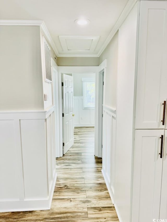 3936 Murrells Inlet Rd, Murrells Inlet, SC 29576 - hall with a decorative wall, attic access, light wood-style floors, crown molding, and wainscoting