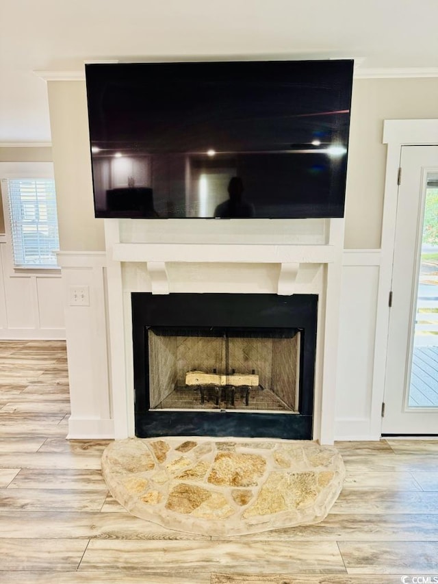 3936 Murrells Inlet Rd, Murrells Inlet, SC 29576 - detailed view of ornamental molding, a decorative wall, wood finished floors, a fireplace with raised hearth, and a wainscoted wall