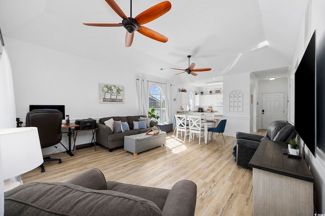 living area featuring baseboards, light wood-style floors, and ceiling fan