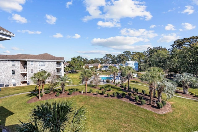 view of home's community featuring a lawn