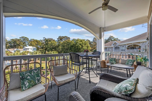 view of patio / terrace with a balcony, a residential view, and ceiling fan