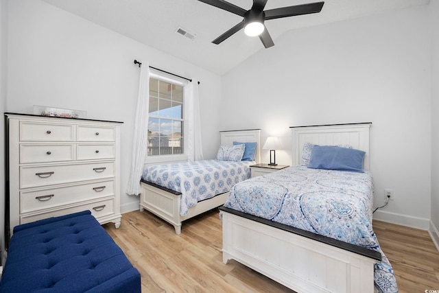 bedroom with visible vents, baseboards, vaulted ceiling, light wood-style floors, and a ceiling fan