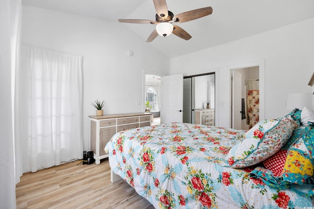 bedroom featuring a closet, wood finished floors, a ceiling fan, and vaulted ceiling