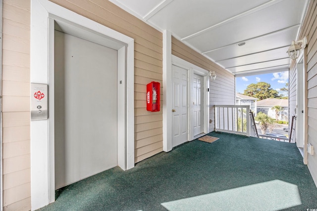 property entrance with elevator and covered porch